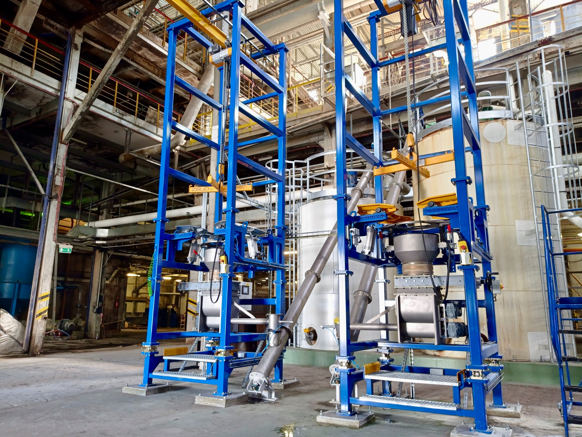 Two big bag emptying stations with screw feeders and docking modules at a sugar refinery
