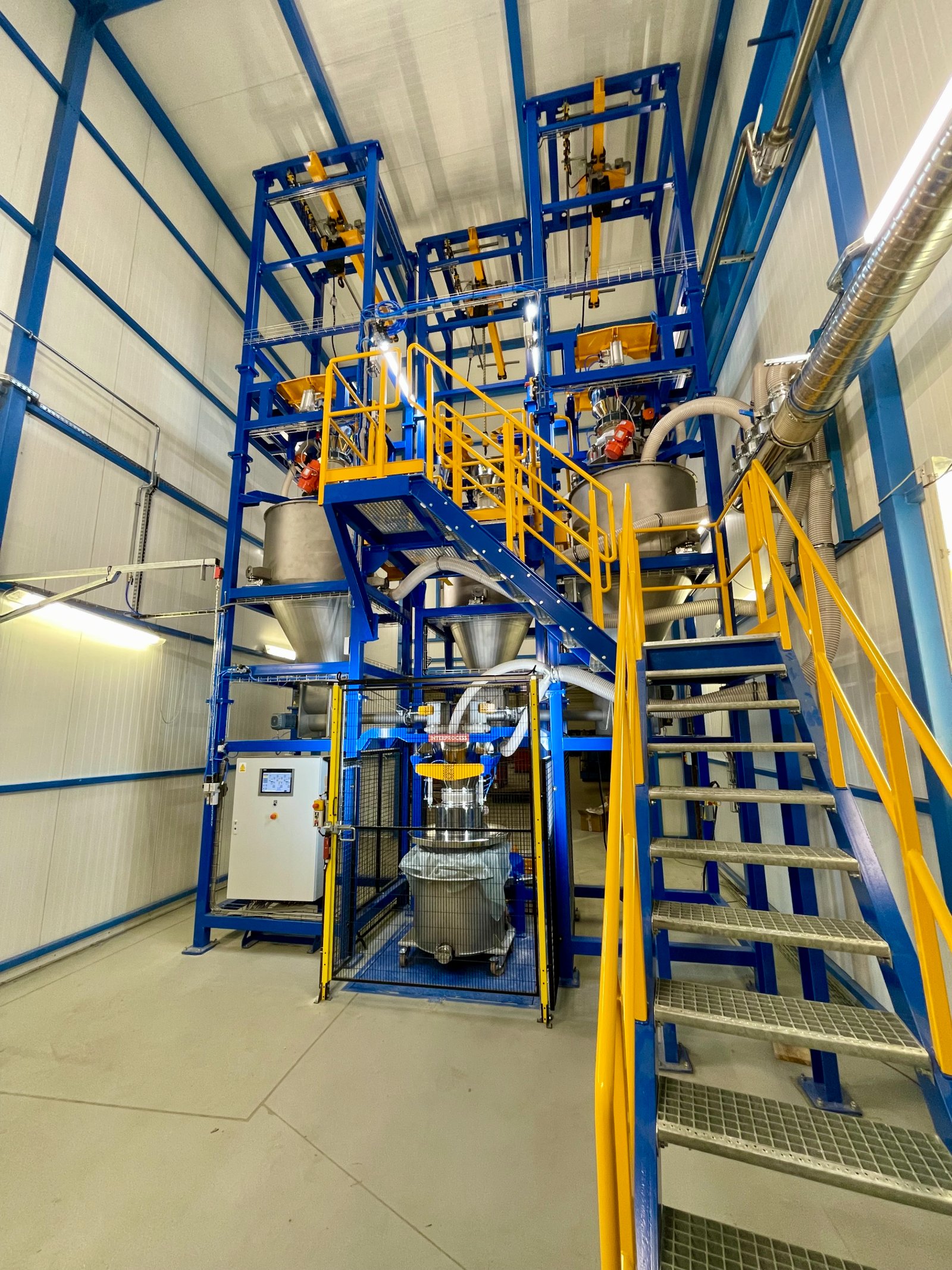 A multi-station big bag emptying system with ingredient batch weighing and pneumatic conveying